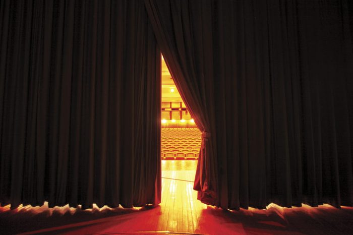 Theater seats through curtains.. behind scene