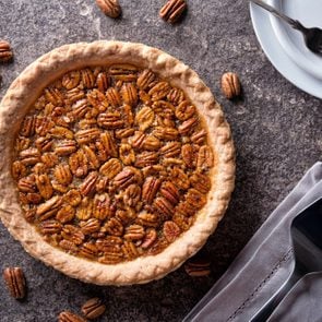 A delicious home made pecan pie on a stone counter top.