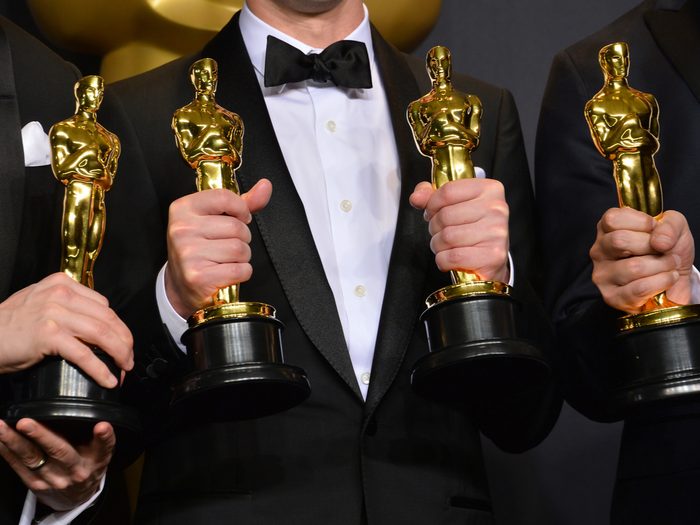 People holding Oscars