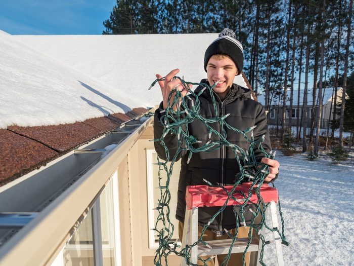 Person putting up Christmas lights