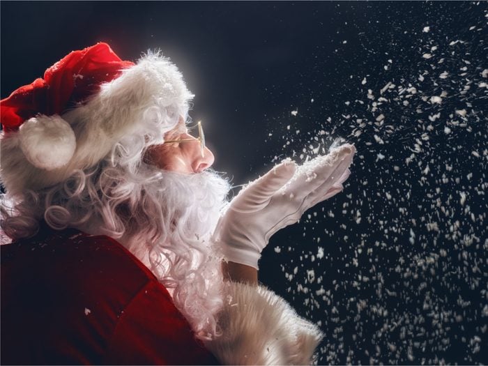 Santa Claus blowing snow