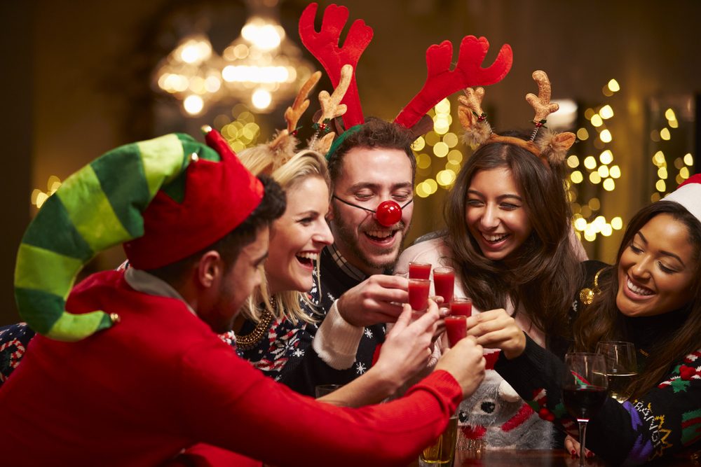 Group Of Friends Enjoying Christmas Drinks In Bar