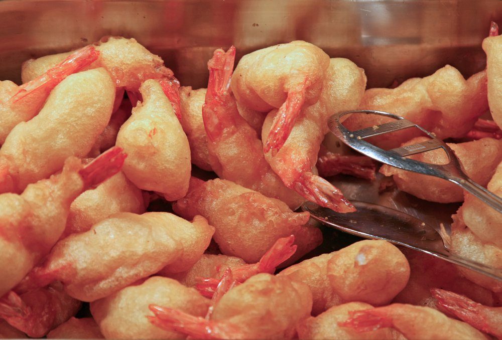 steel tray filled with shrimp and fried crawfish tails in a restaurant take away