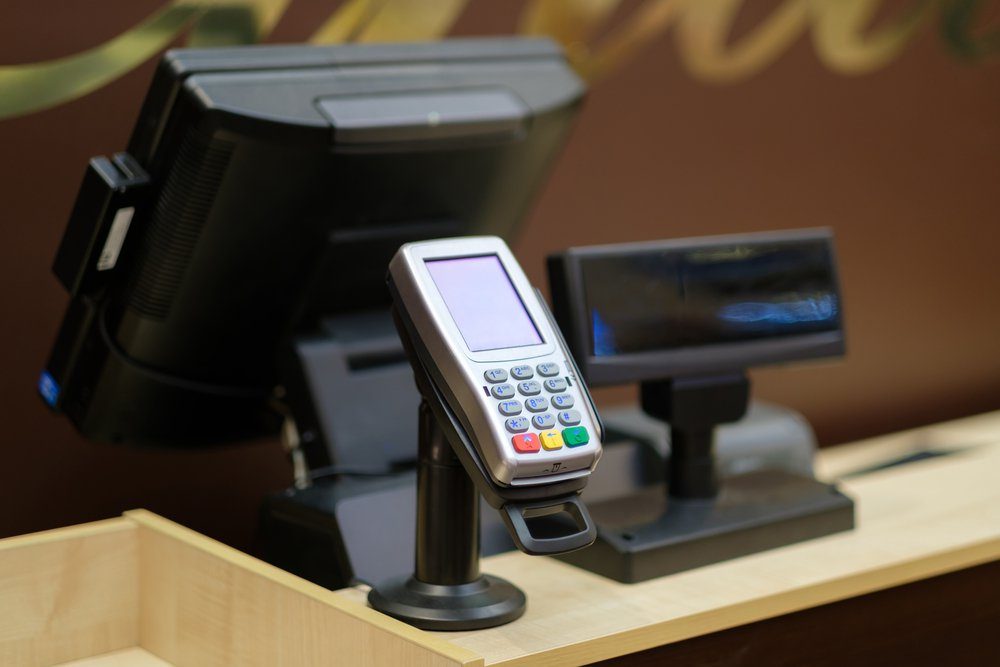 Cash desk with screen and card payment terminal in mall