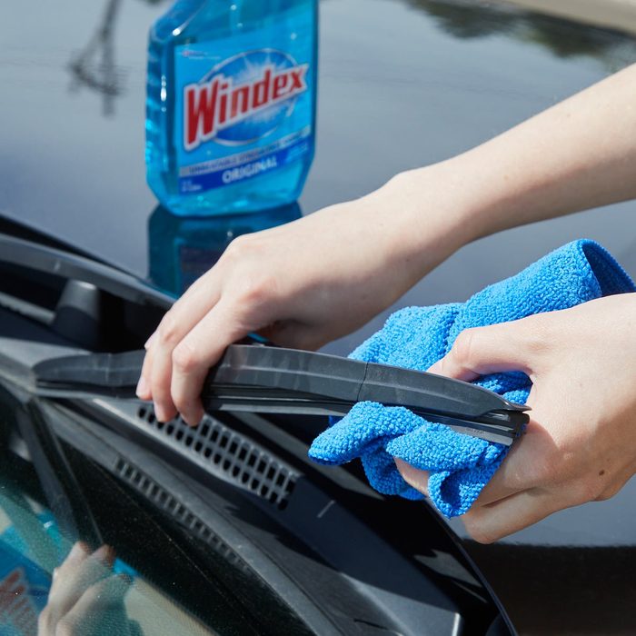 HH clean windshield wipers with windex