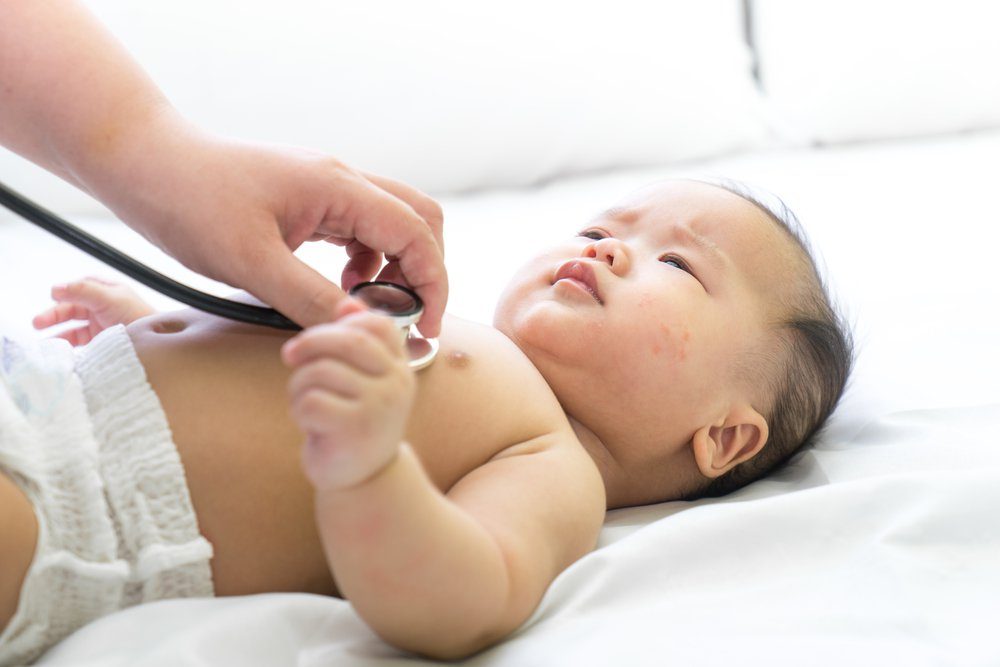 Doctor exams Asian newborn baby with stethoscope in the hospital