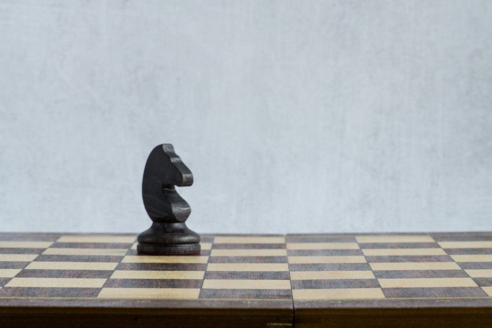 A lonely black horse on the chessboard