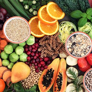 Health food concept for a high fiber diet with fruit, vegetables, cereals, whole wheat pasta, grains, legumes and herbs. Foods high in anthocyanins, antioxidants, smart carbohydrates and vitamins.