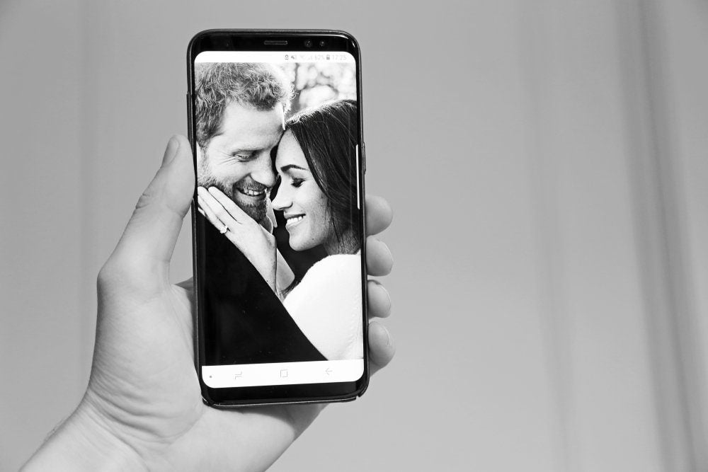 Phone with picture of Prince Harry and Meghan Markle