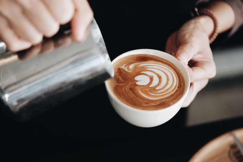 how to make latte art by barista focus in milk and coffee in vintage color