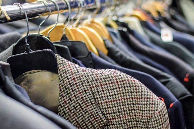 Rack of men's suit jackets hanging in boutique store