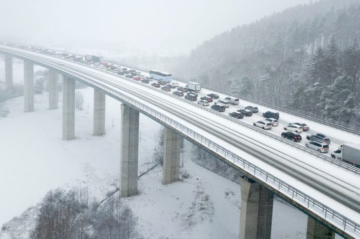 Aerial view over a highway bridge during a heavy snowfall in winter