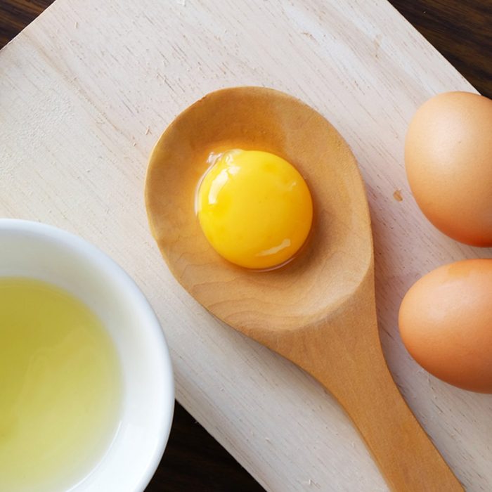 Egg yolk on wooden spoon