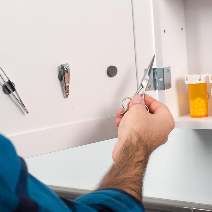 Home organizing hacks mount magnets inside a medicine cabinet