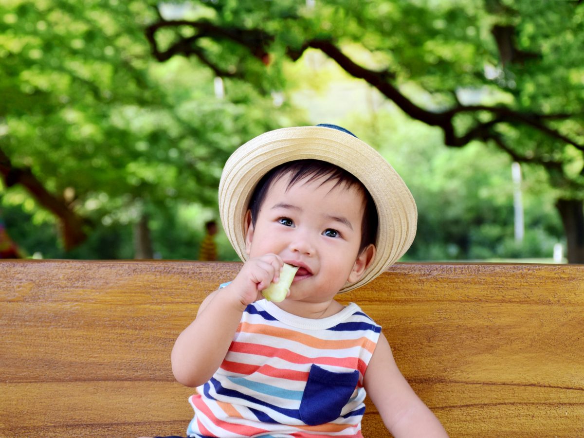 Cute baby eating fruit