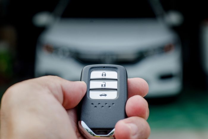 Car smart key is an electronic access and authorization system, Hand holding smart key of car.