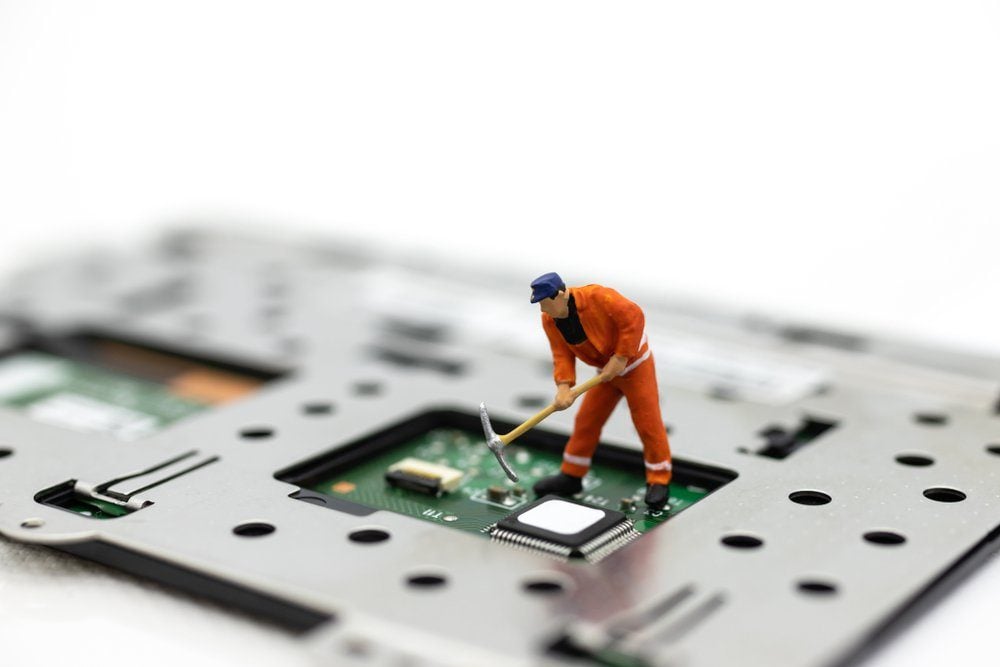 Miniature people: Worker repairing circuit board ,electronics repair. Use image for support and maintenance business.