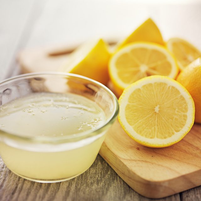 freshly squeezed lemon juice in small bowl; Shutterstock ID 211542739