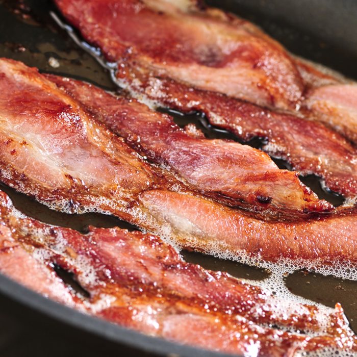 Bacon strips sizzling on a frying pan; Shutterstock ID 29677456; Job (TFH, TOH, RD, BNB, CWM, CM): Taste of Home