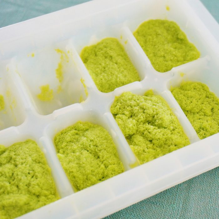 Making pesto in an ice cube tray; Shutterstock ID 438801295