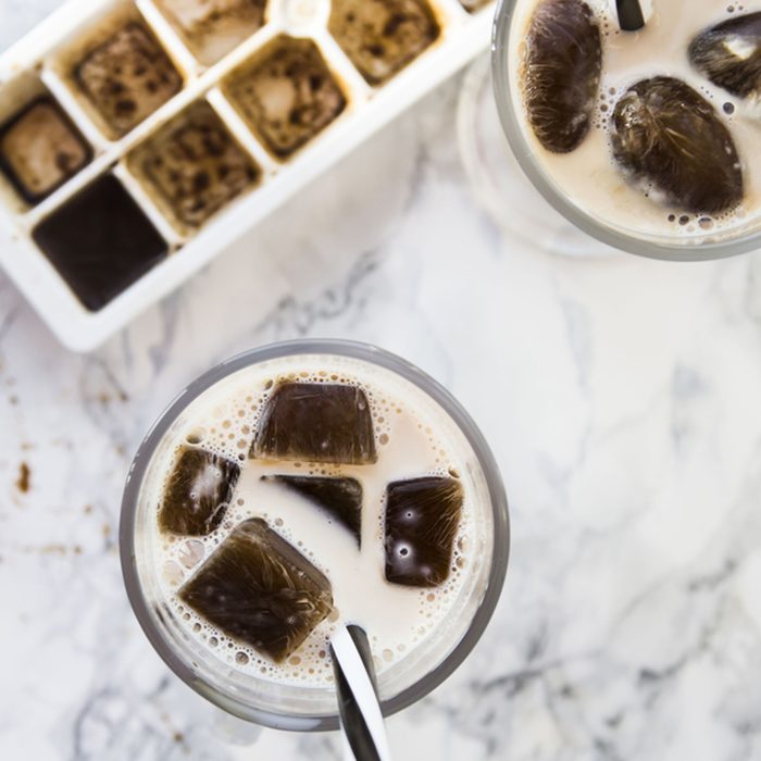 frozen coffee cubes with milk - cocktails on marble table; Shutterstock ID 565170853