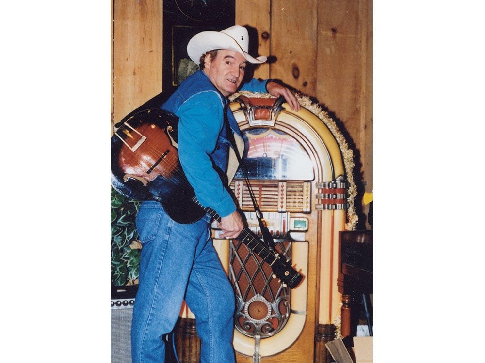 Michael T. Wall standing next to his vintage jukebox