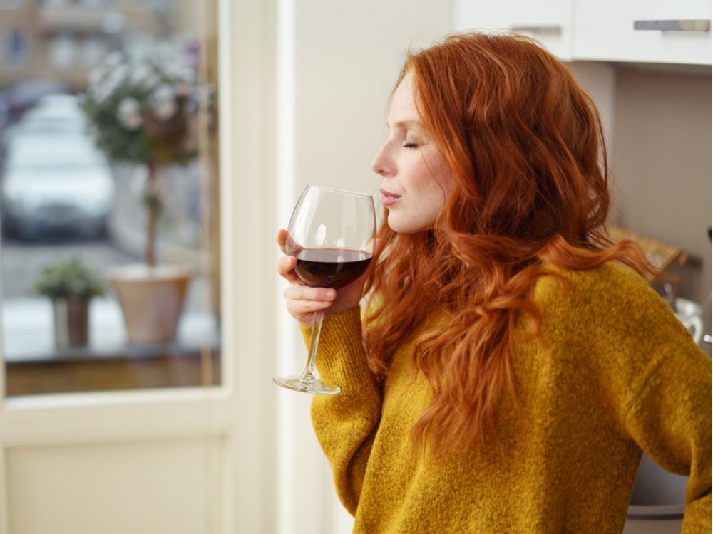 Redhead woman drinking wine