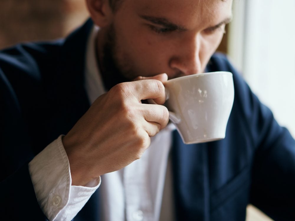 Man in suit drinking coffee