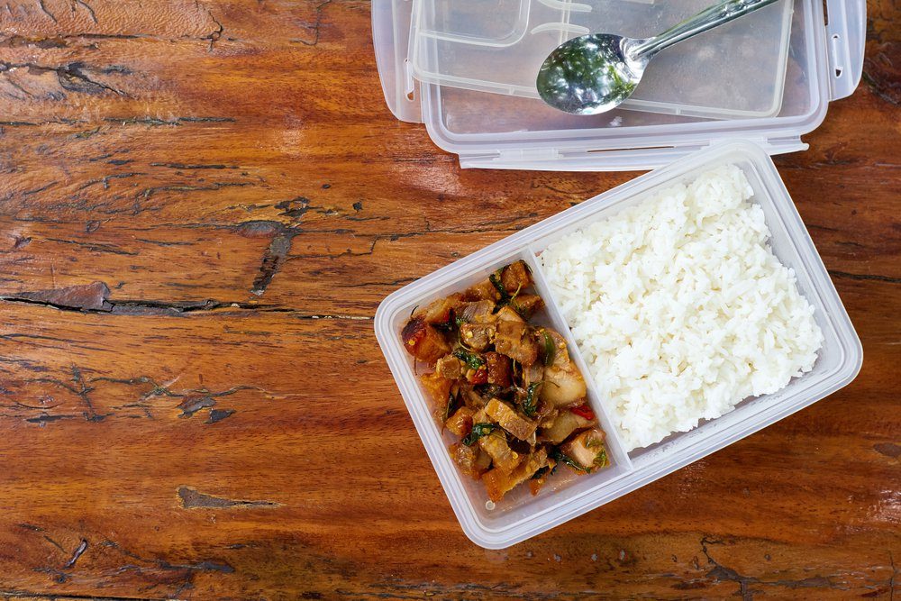 Copy Space.Packed lunch, Sack lunch, Bag lunch, Brown-bag lunch, Boxed lunch,Lunch Box.Thai Spicy Basil with Crispy Pork Belly with Rice