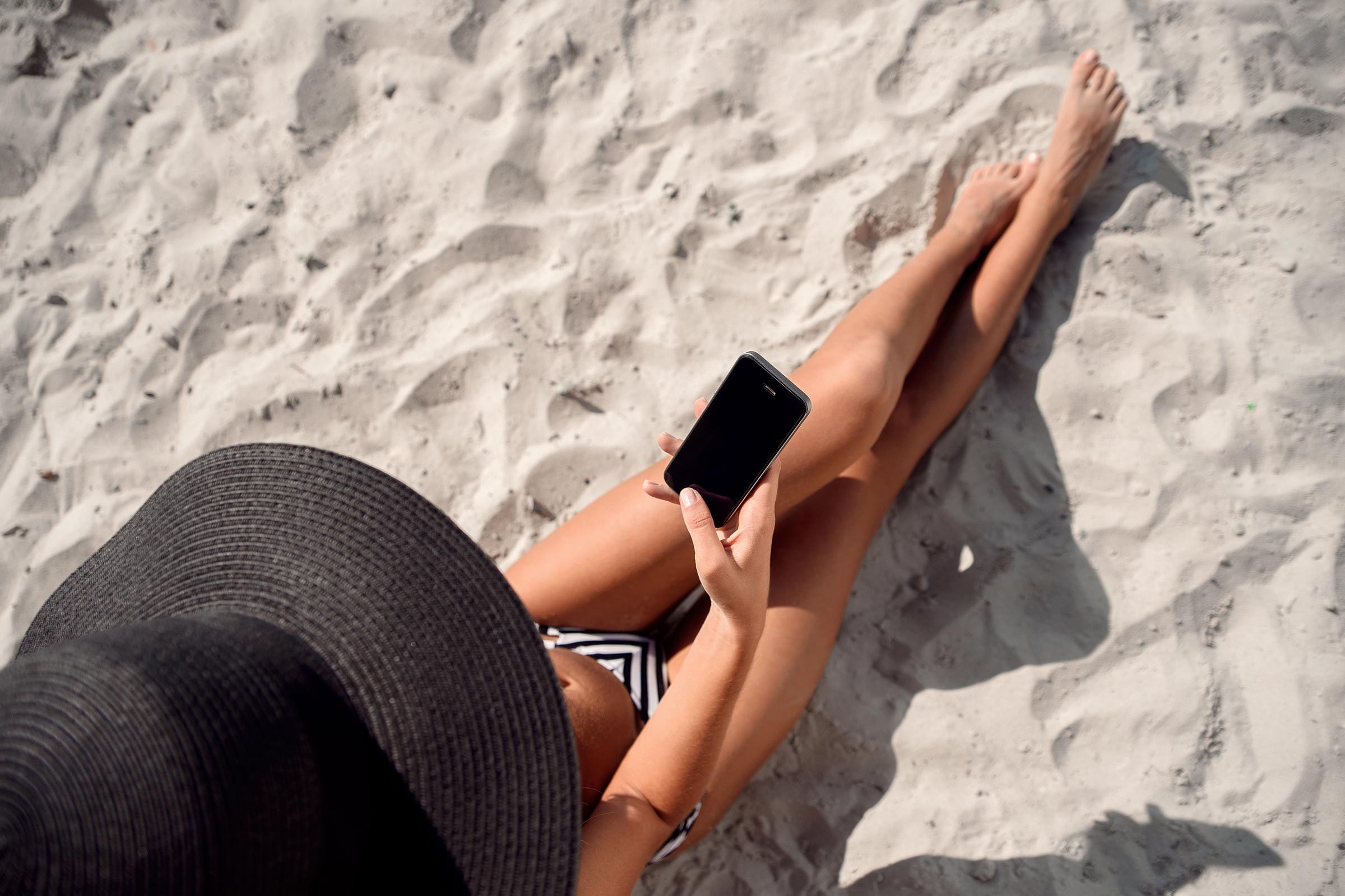 phone beach sand woman
