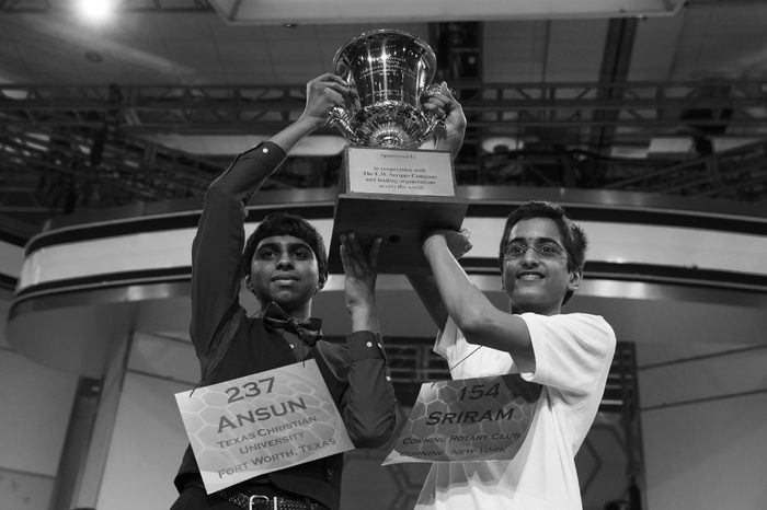 Ansun Sujoe, 13, of Fort Worth, Texas, left, and Sriram Hathwar, 14, of Painted Post, N.Y., raise the championship trophy after being named co-champions of the National Spelling Bee,, in Oxon Hill, Md