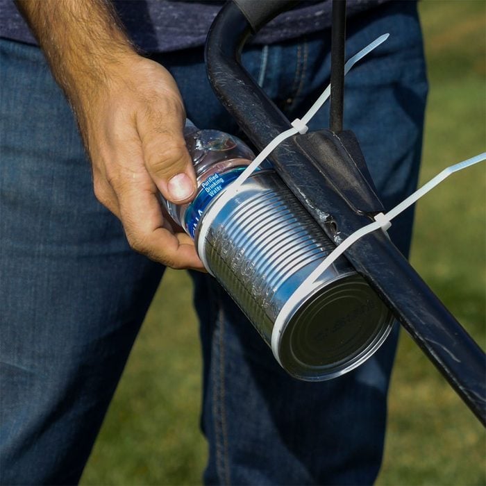 placing water bottle in tin can holder