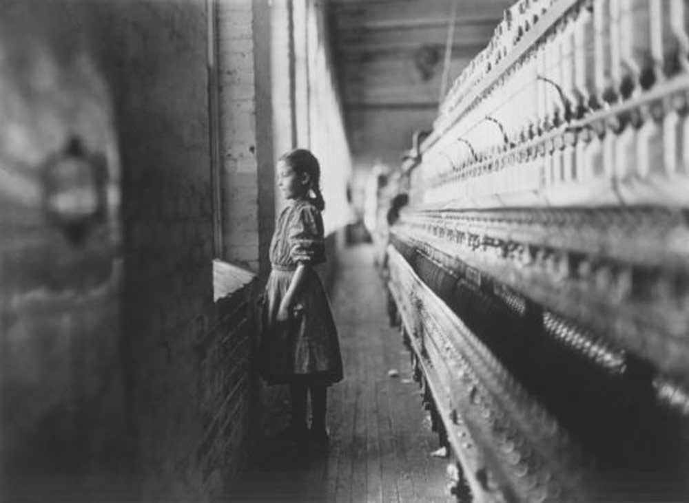 Young girl working at a cotton mill