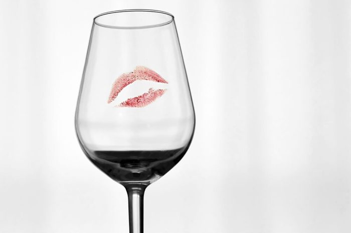 A red mark of a lipstick on a glass.