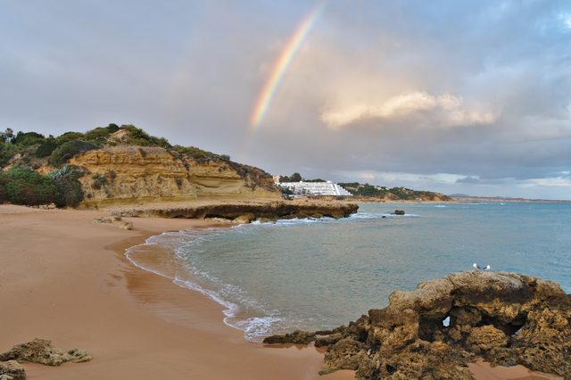 Beautiful Rainbow sight in Aveiros beach. Albufeira, Algarve, Portugal