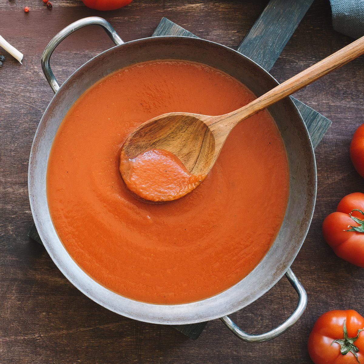 Tomato sauce in pan. Top view wooden brown background; Shutterstock ID 1380828656; Job (TFH, TOH, RD, BNB, CWM, CM): TOH
