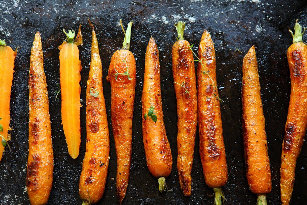 baked carrots on a baking sheet, food close up