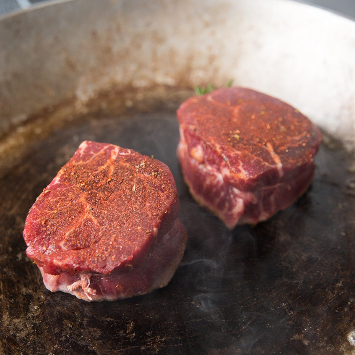 Two Filet Mignon Steaks Being Cooked on Hot Stainless Steel Skillet; Shutterstock ID 224139040; Job (TFH, TOH, RD, BNB, CWM, CM): TOH
