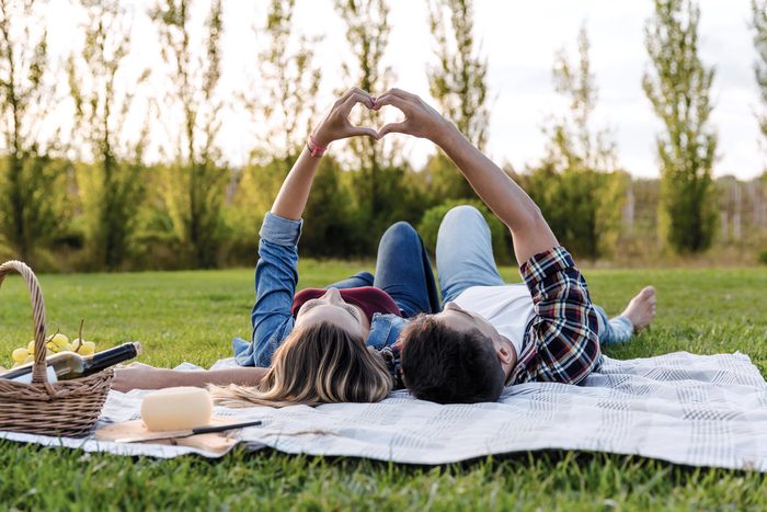how to live to 100 - Happy couple in love, lying on the park and enjoying the day together