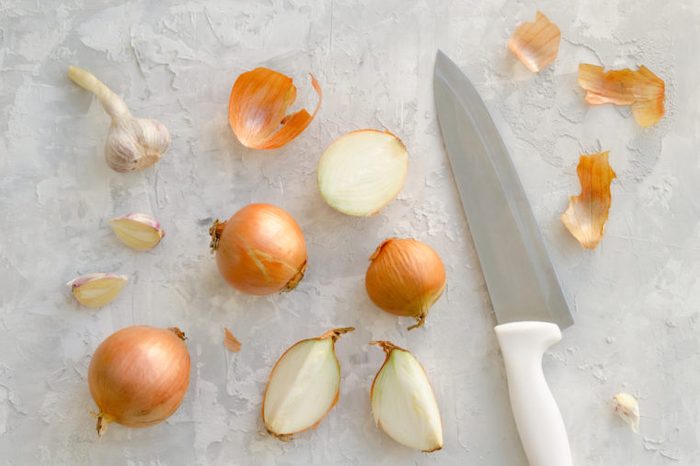 Onions on a concrete background. Overhead shot. Top view