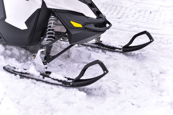 Snowmobile skiing on snow close up