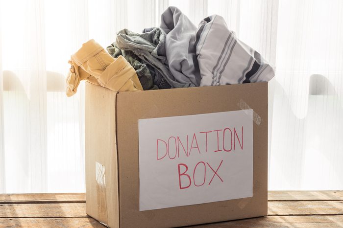 Clothing donation box on wooden background