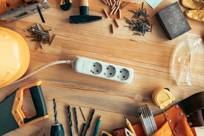 Power strip extension cord on carpentry woodwork woodwork desk, top view