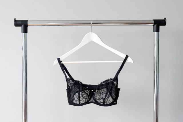 Black lace bra hanging on a hanger. Textile, Underwear. Female bra in lingerie underwear store. Advertise, sale, fashion concept.