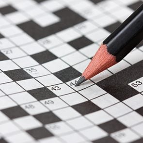 crossword puzzle and pencil