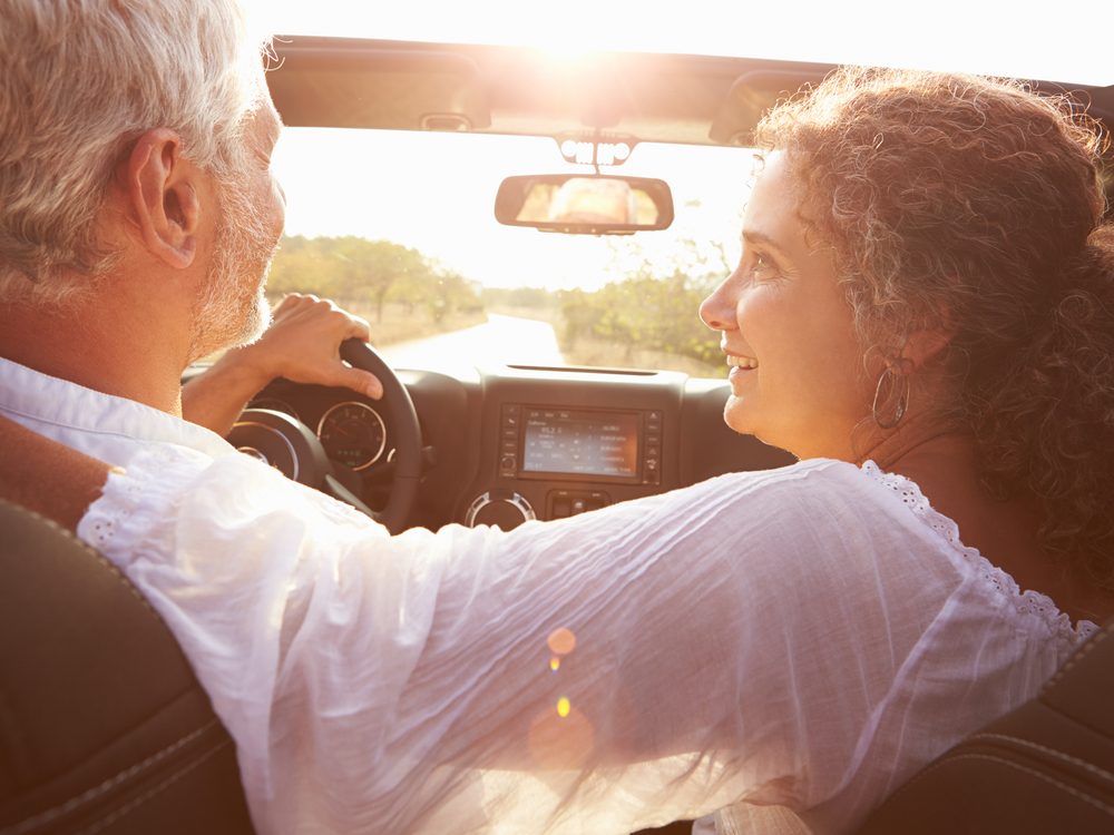 Older couple driving in summertime