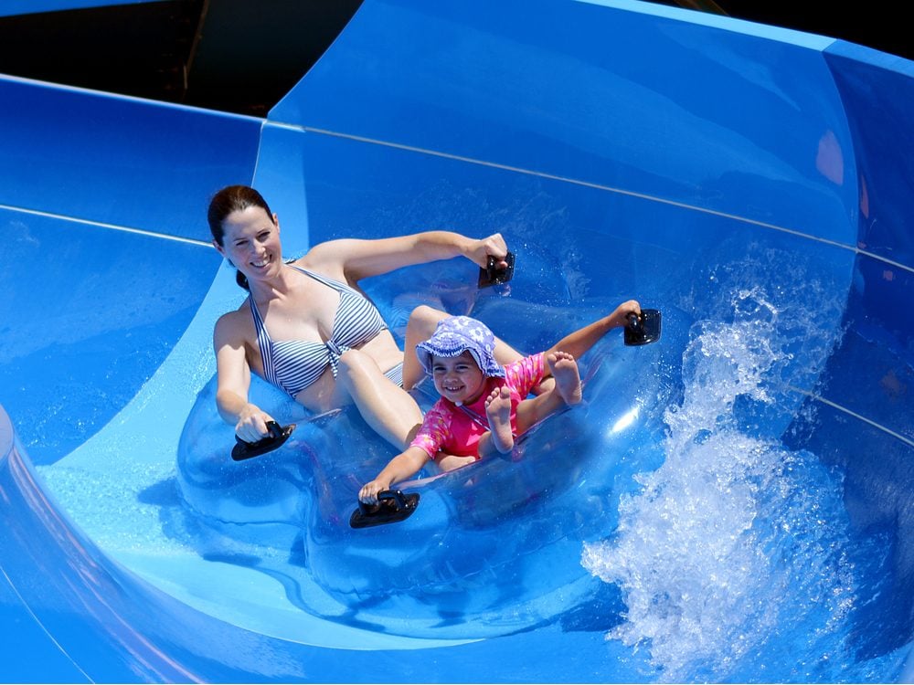 Mother and daughter having fun on water slide
