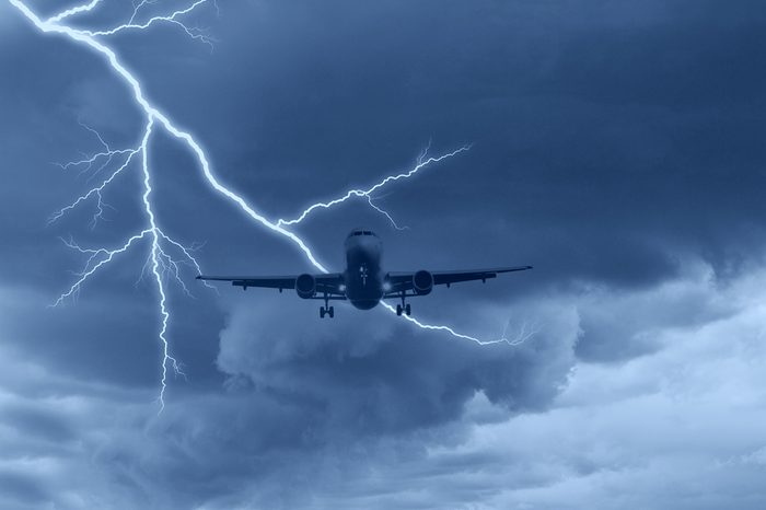 airplane in the sky with lightning