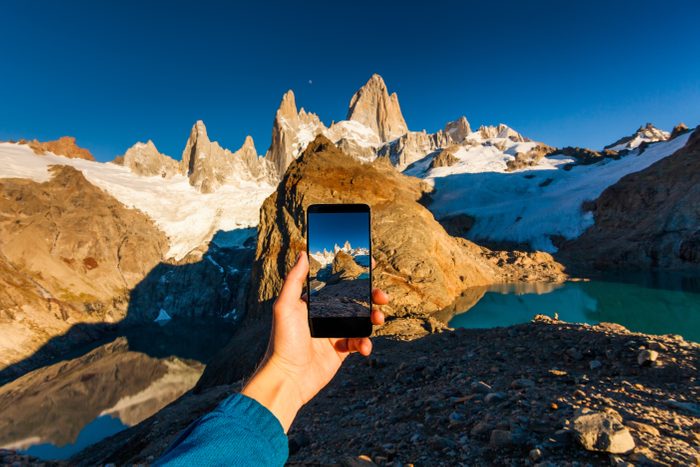 Taking a photo of mountains on a smartphone. Patagonia.