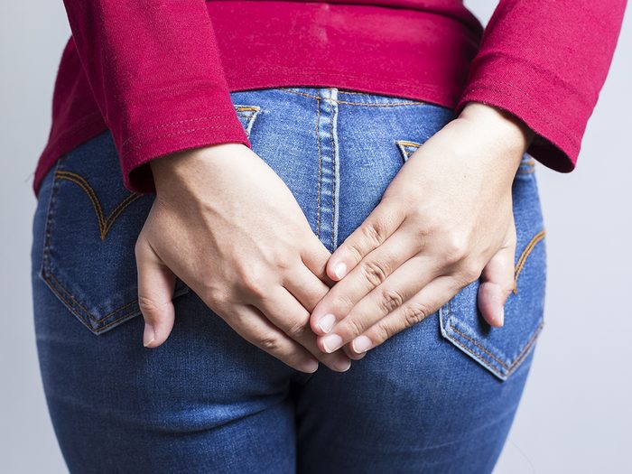 What your poop says about your health - woman holding in fart